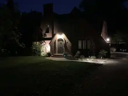 Bacon Project at night: path and uplights on the walk and the Tudor facade