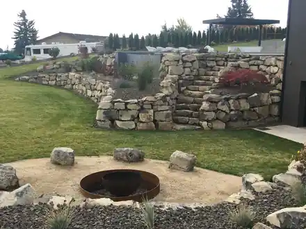 Froula Project: a fire pit circle below the finished boulder terraces and stairs