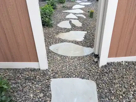Forrest Project: large flagstones set in gravel beside a house